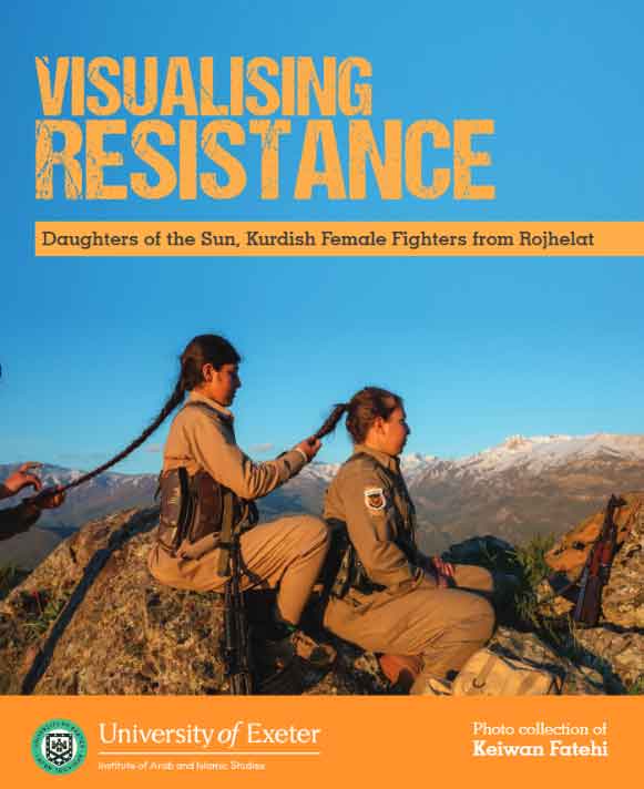 female soldiers plating each others hair in a row with mountains in background