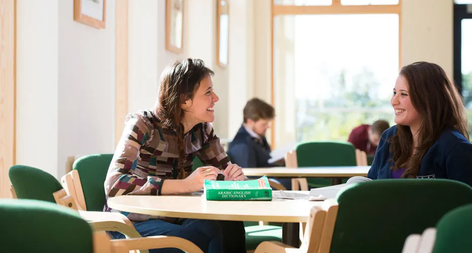 Two female students talking in IAIS cafe